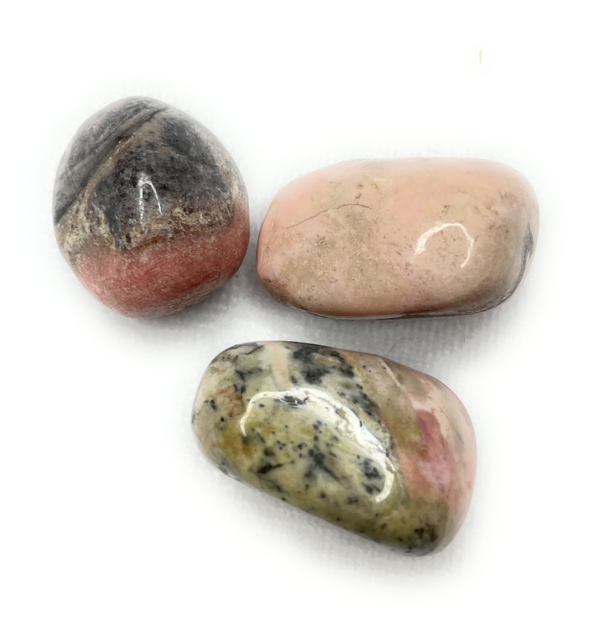 Tumbled Rhodonite Stone - A unique handcrafted crystal piece.